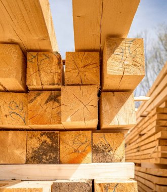 Stack of construction wood planks prepared for build a house